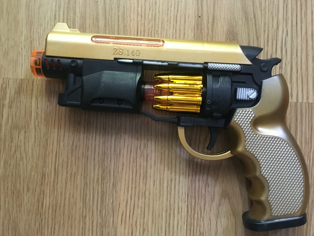 Zabawka złoty rewolwer pistolet świetlny na baterie